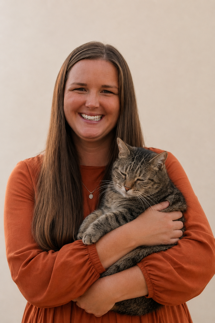 Dr Beth Gillis holding a relaxed tabby cat